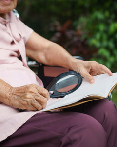 picture of old lady using magnifying glass
