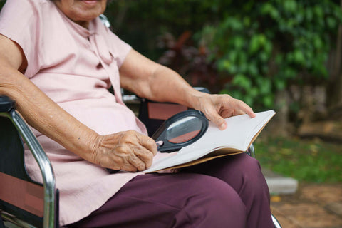 picture of old lady using magnifying glass