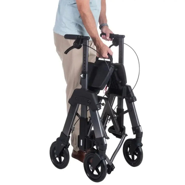 User folding the Heavy Duty EZ Fold and Go Rollator for easy transport and storage.