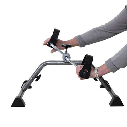 Person using a Pedal Exerciser to enhance strength and coordination, featuring durable steel frame and non-slip tips.