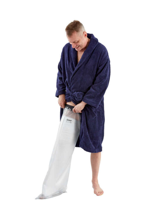 Man in a blue robe putting on a waterproof adult full leg protector for bathing and swimming.