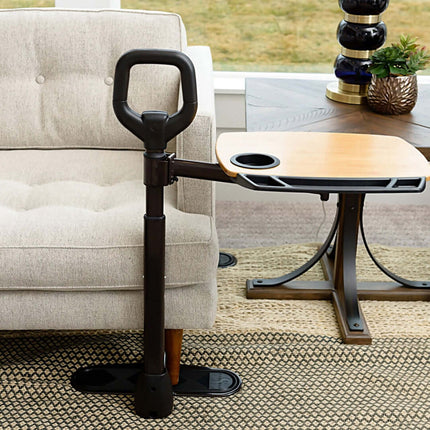 Stander Assist-A-Tray with ergonomic grip handle and swivel tray next to a sofa for safety and convenience.