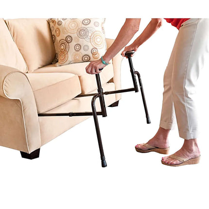 Person using EZ Stand N Go support device to assist with standing from a sofa, enhancing mobility and confidence.