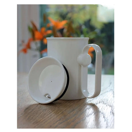 Handsteady drinking aid with a rotating handle and cup designed for easy sipping without wrist movement.